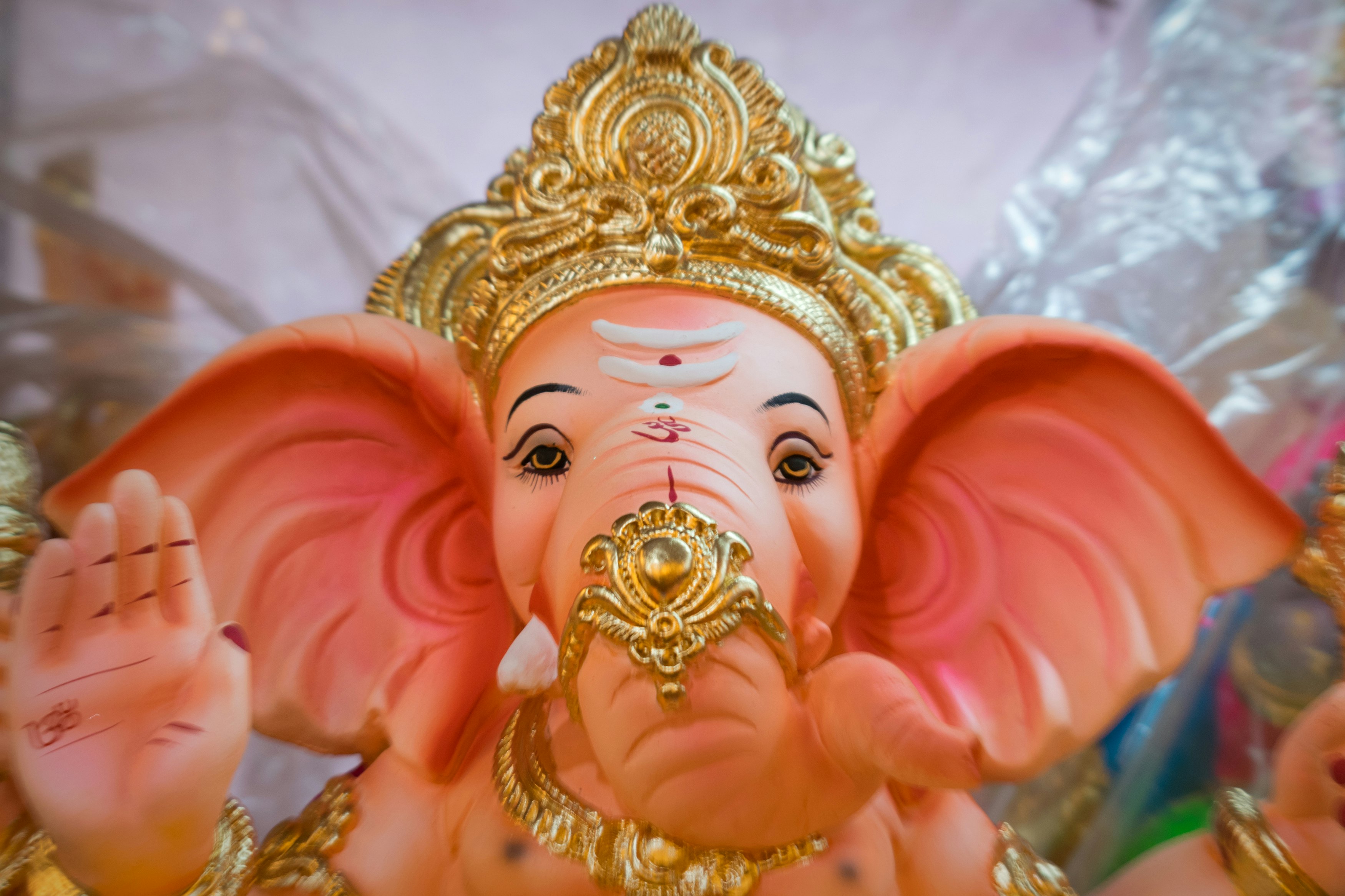gold and pink hindu deity figurine